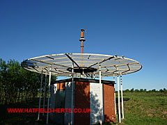 Hatfield airfield radio beacon - orange and white structure under a circular antennae array