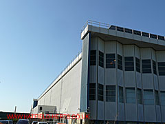 south east side of the hangar with a solid aluminium curtain wall and the projecting Esavian door ends