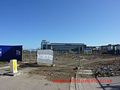 Cleared site of the 146 Hangar with the Flight Test Hangar visible in the background