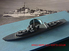 River class frigate demonstration model against photo of a River class frigate