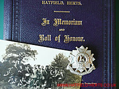 Hatfield memorial book, Hatfield Volunteer Training Corps postcard, and Bedfordshire and Hertfordshire Regiment badge