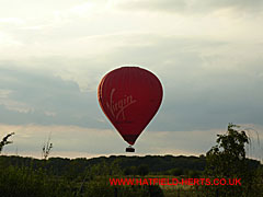 Red Virgin Balloon seen low over Ellenbrook Fields