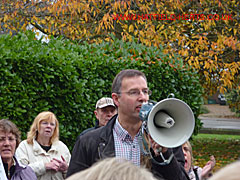 Protestors being addressed through a megaphone by Nigel Quinton