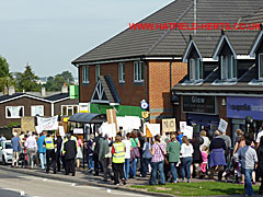 Marchers passing the Coop and shops on Bishops Rise