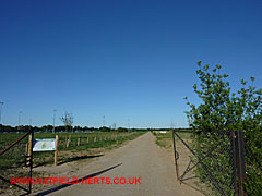 Looking through the entrance gates from Ellenbrook Park up the former airfield track