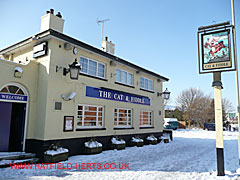 snow covered Cat and Fiddle pub