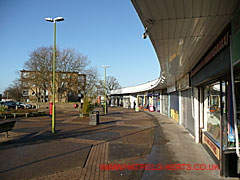 An arc of shops that is the Hilltop shopping precinct