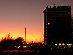 Sunset over Hatfield town centre - Queensway House tower block silhouetted