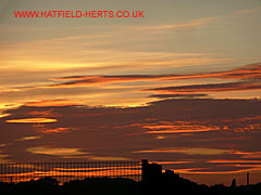 sunset sky over the de Havilland campus playing fields - clouds turn red