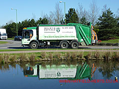 Green and white Welwyn Hatfield Borough Council refuse truck