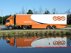 Orange and white TNT truck and trailer