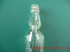 Close up of indentations in the neck of the Codd bottle