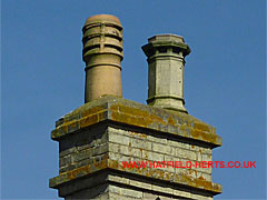 Close up of buff clay or stoneware pots on stack at Lemsford Cottage