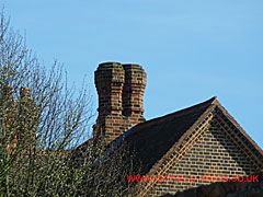 Close up of the brick twin stack on the left gable