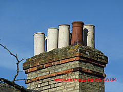 Buff or stone coloured Plain Roll Taper pots with a single terracotta Two Roll pot on a single stack