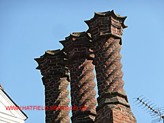 Elaborate spiral brick chimney with star crowns