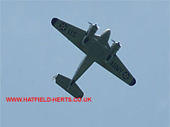 Twin engine Beech from directly below, silver finish with US Army markings