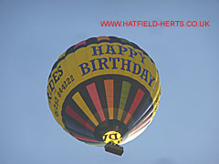 Lindstrand LBL 330A - multicoloured balloon with the words Happy Birthday visible in a yellow band around the centre
