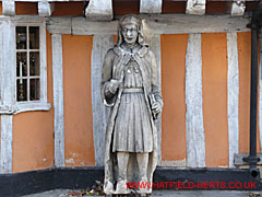 white painted wooden statue outside shop