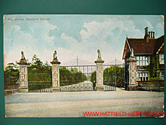 Colourised postcard showing the gates of Hatfield House